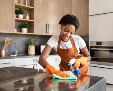 part-time-cleaner-cleaning-kitchen-countertop